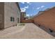 A gravel backyard with minimalist landscaping and a wall providing privacy to the property at 5589 Pico Ferrera Ct, Las Vegas, NV 89113