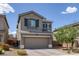 Attractive two-story home featuring a large two-car garage and desert landscaping at 5589 Pico Ferrera Ct, Las Vegas, NV 89113