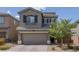 Inviting two-story home with a well-manicured front yard and a two-car garage at 5589 Pico Ferrera Ct, Las Vegas, NV 89113