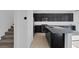 Kitchen with granite counters, stainless appliances, and dark cabinets, and a view of stairs at 5589 Pico Ferrera Ct, Las Vegas, NV 89113