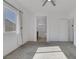 This bright main bedroom features carpet, a ceiling fan, and a convenient ensuite bathroom at 5589 Pico Ferrera Ct, Las Vegas, NV 89113