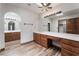 Spacious primary bathroom featuring double vanity, wood cabinets, and modern light fixtures at 6861 E Washington Ave, Las Vegas, NV 89110
