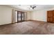 Bedroom featuring a ceiling fan, carpet, and glass doors leading to the back patio at 6861 E Washington Ave, Las Vegas, NV 89110