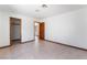 A light and bright bedroom with tile flooring and an open doorway to the hallway at 6861 E Washington Ave, Las Vegas, NV 89110