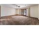 Bright and airy bedroom featuring plush carpeting, a ceiling fan, and access to the backyard at 6861 E Washington Ave, Las Vegas, NV 89110