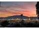 Breathtaking skyline view with colorful buildings and palm trees, set against a vibrant sunset at 6861 E Washington Ave, Las Vegas, NV 89110