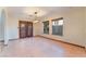 Spacious dining room with tile flooring, a stylish light fixture, and glass paneled doors at 6861 E Washington Ave, Las Vegas, NV 89110