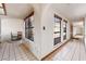 Bright hallway with arched doorways, tiled floors, and large windows at 6861 E Washington Ave, Las Vegas, NV 89110