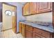 Laundry room has granite countertops and matching wood cabinets with a doorway at 6861 E Washington Ave, Las Vegas, NV 89110