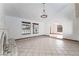 Large living room featuring a tile fireplace, chandelier, neutral tile, and arched doorways at 6861 E Washington Ave, Las Vegas, NV 89110