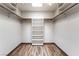 Walk-in closet with custom shelving and wood laminate flooring with a skylight at 6861 E Washington Ave, Las Vegas, NV 89110