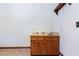 Wet bar area with wood cabinetry, tile backsplash and tile floor at 6861 E Washington Ave, Las Vegas, NV 89110