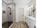 Bright bathroom featuring a glass-enclosed shower and double vanity with white cabinets at 8276 Aurora Peak Ave, Las Vegas, NV 89131