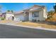 Inviting single-story home with a two-car garage, desert landscaping, and a tile roof at 8276 Aurora Peak Ave, Las Vegas, NV 89131