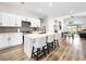 New kitchen features stainless appliances, white cabinets, and island seating at 8276 Aurora Peak Ave, Las Vegas, NV 89131