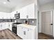 Modern kitchen features sleek appliances, white cabinets, and decorative backsplash at 8276 Aurora Peak Ave, Las Vegas, NV 89131