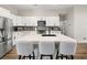Spacious kitchen with stainless steel appliances, a large island with seating, and white cabinetry at 8276 Aurora Peak Ave, Las Vegas, NV 89131