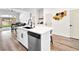 Kitchen island features bar stool seating, black faucet, and stainless dishwasher at 8276 Aurora Peak Ave, Las Vegas, NV 89131