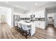 Kitchen boasts stainless appliances, ample cabinets, and island with bar stools at 8276 Aurora Peak Ave, Las Vegas, NV 89131