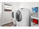 Bright laundry room features a washer and dryer with storage at 8276 Aurora Peak Ave, Las Vegas, NV 89131