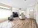 Inviting living room with hardwood floors, comfortable seating, and lots of natural light at 8276 Aurora Peak Ave, Las Vegas, NV 89131