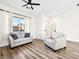 Comfortable living room featuring neutral decor, hardwood floors, and lots of natural light at 8276 Aurora Peak Ave, Las Vegas, NV 89131