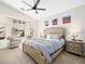 Serene main bedroom features neutral colors, a ceiling fan, and abundant natural light at 8276 Aurora Peak Ave, Las Vegas, NV 89131