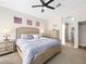Inviting main bedroom with neutral tones, including a ceiling fan and ensuite bathroom at 8276 Aurora Peak Ave, Las Vegas, NV 89131