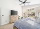 Spacious main bedroom with ceiling fan, dresser, and large windows overlooking the backyard at 8276 Aurora Peak Ave, Las Vegas, NV 89131