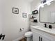 Powder room featuring modern black hardware and stylish floating shelves at 8276 Aurora Peak Ave, Las Vegas, NV 89131