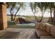 Backyard oasis featuring a custom rock waterfall feature, spa, and lush landscaping at 9 Knob Oak Dr, Henderson, NV 89052