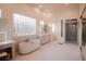 Bright bathroom featuring a soaking tub, walk-in shower, dual vanities, and ample natural light at 9 Knob Oak Dr, Henderson, NV 89052