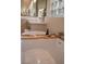 Modern bathroom featuring a large tub with a bamboo tray and vanity with a lighted mirror at 9 Knob Oak Dr, Henderson, NV 89052