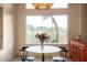 Bright breakfast nook with large window view and seating for two next to an orange cabinet at 9 Knob Oak Dr, Henderson, NV 89052
