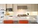Modern kitchen showcasing stainless steel appliances, a spacious island, and pristine white cabinetry at 9 Knob Oak Dr, Henderson, NV 89052