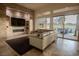 Comfortable living room featuring a modern fireplace, large windows, and access to the patio at 9 Knob Oak Dr, Henderson, NV 89052