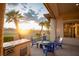 Outdoor patio with built-in grill, fire pit, and comfortable seating area, perfect for entertaining at 9 Knob Oak Dr, Henderson, NV 89052