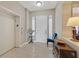 Inviting condo foyer featuring tile flooring, a white door, and an elevator access point at 9213 Las Manaitas Ave # 401, Las Vegas, NV 89144