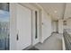Condo entryway with a white front door, adjacent windows, and an exterior hallway at 9213 Las Manaitas Ave # 401, Las Vegas, NV 89144