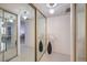 Hallway with mirrored closet doors, tile floors, and view into the bedroom at 205 E Harmon Ave # 803, Las Vegas, NV 89169