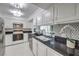 Bright kitchen featuring white cabinets, black countertops, stainless steel appliances and tile backsplash at 205 E Harmon Ave # 803, Las Vegas, NV 89169