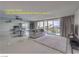 Bright living room featuring a sofa, glass doors to a balcony, and mirrored wall in a condo at 205 E Harmon Ave # 803, Las Vegas, NV 89169