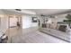 Inviting living room with a white sofa, tile floors, mirrors, and a view into an open kitchen at 205 E Harmon Ave # 803, Las Vegas, NV 89169