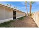 View of the home's exterior and backyard with palm trees at 254 Reber Dr, Mesquite, NV 89027