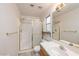 Bathroom featuring a glass enclosed shower, single sink vanity, and a window for natural light at 254 Reber Dr, Mesquite, NV 89027