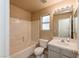 Well-lit bathroom featuring a shower-tub combo, vanity sink, and a neutral color scheme at 254 Reber Dr, Mesquite, NV 89027