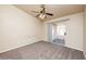 Bedroom featuring neutral carpet, a ceiling fan, and a sliding glass door to the backyard at 254 Reber Dr, Mesquite, NV 89027