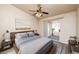 Primary bedroom with a ceiling fan, a sliding glass door, and a contemporary aesthetic at 254 Reber Dr, Mesquite, NV 89027
