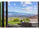 Expansive city views from the home's patio with lounge seating and natural landscaping at 387 Solitude Peak Ln, Henderson, NV 89012