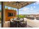 Inviting outdoor patio with TV, dining furniture, and city views at 387 Solitude Peak Ln, Henderson, NV 89012